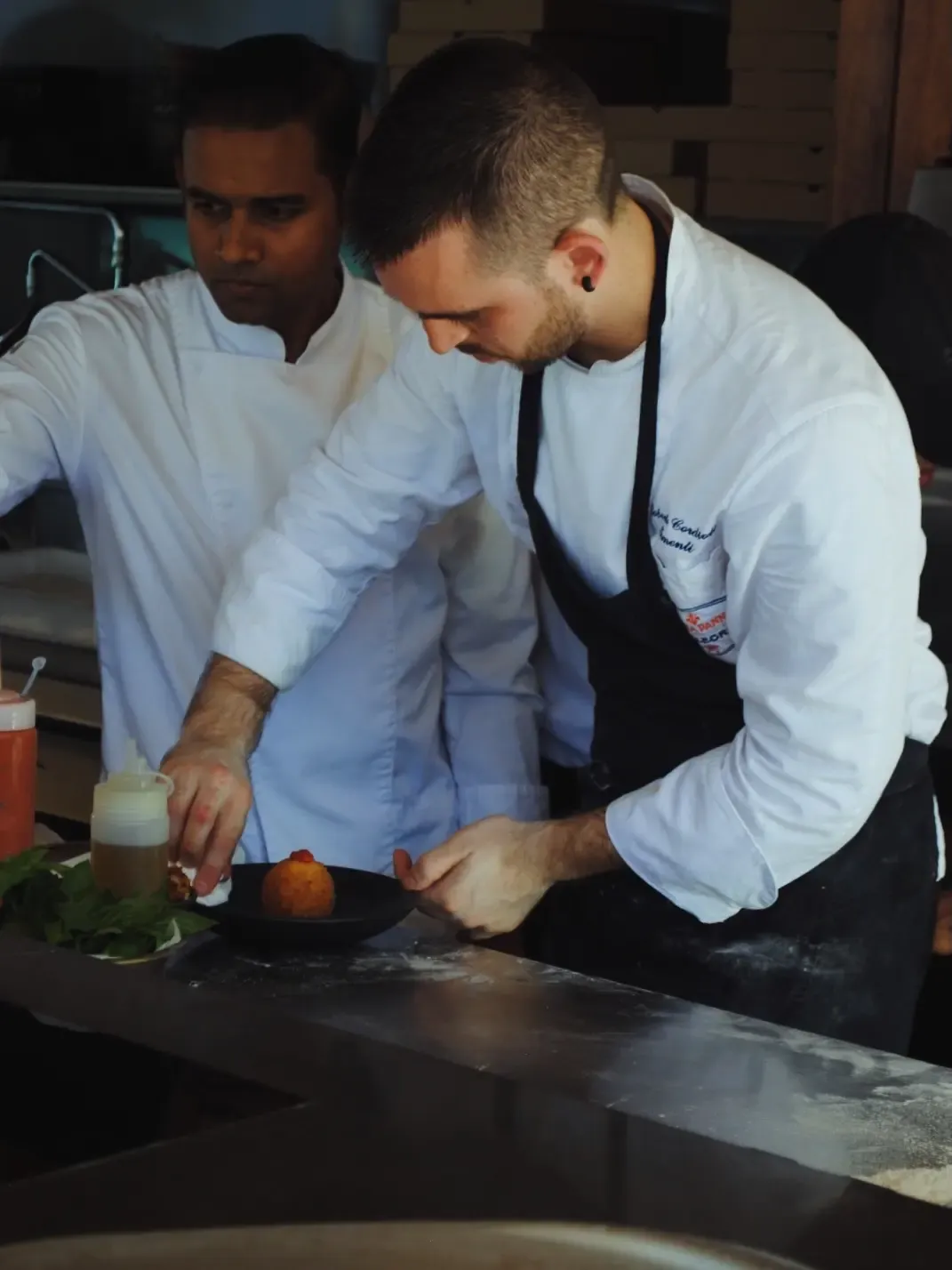 Two chefs at Elementi plating a dish