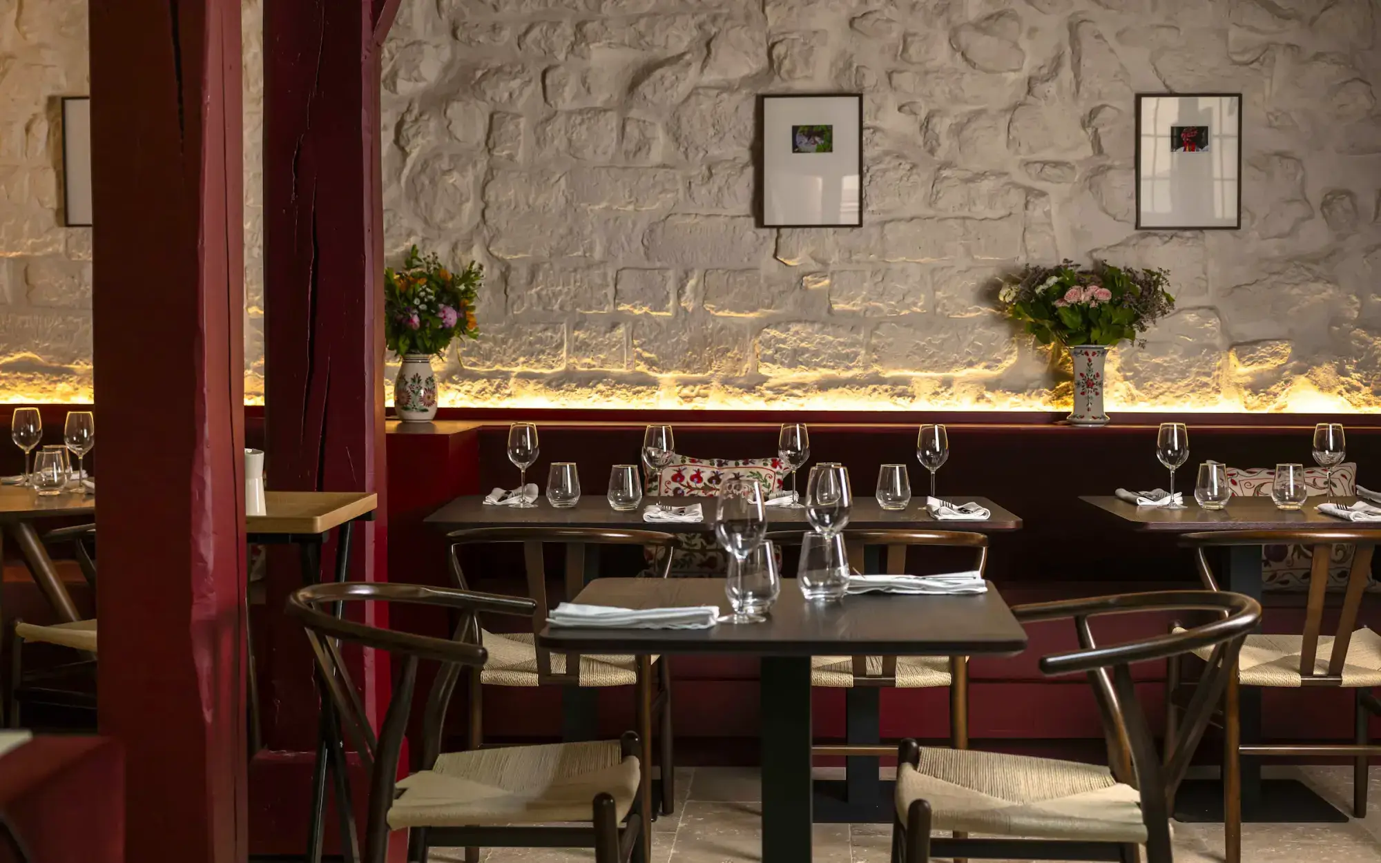 Matka’s dining room, stone walls and burgundy banquettes
