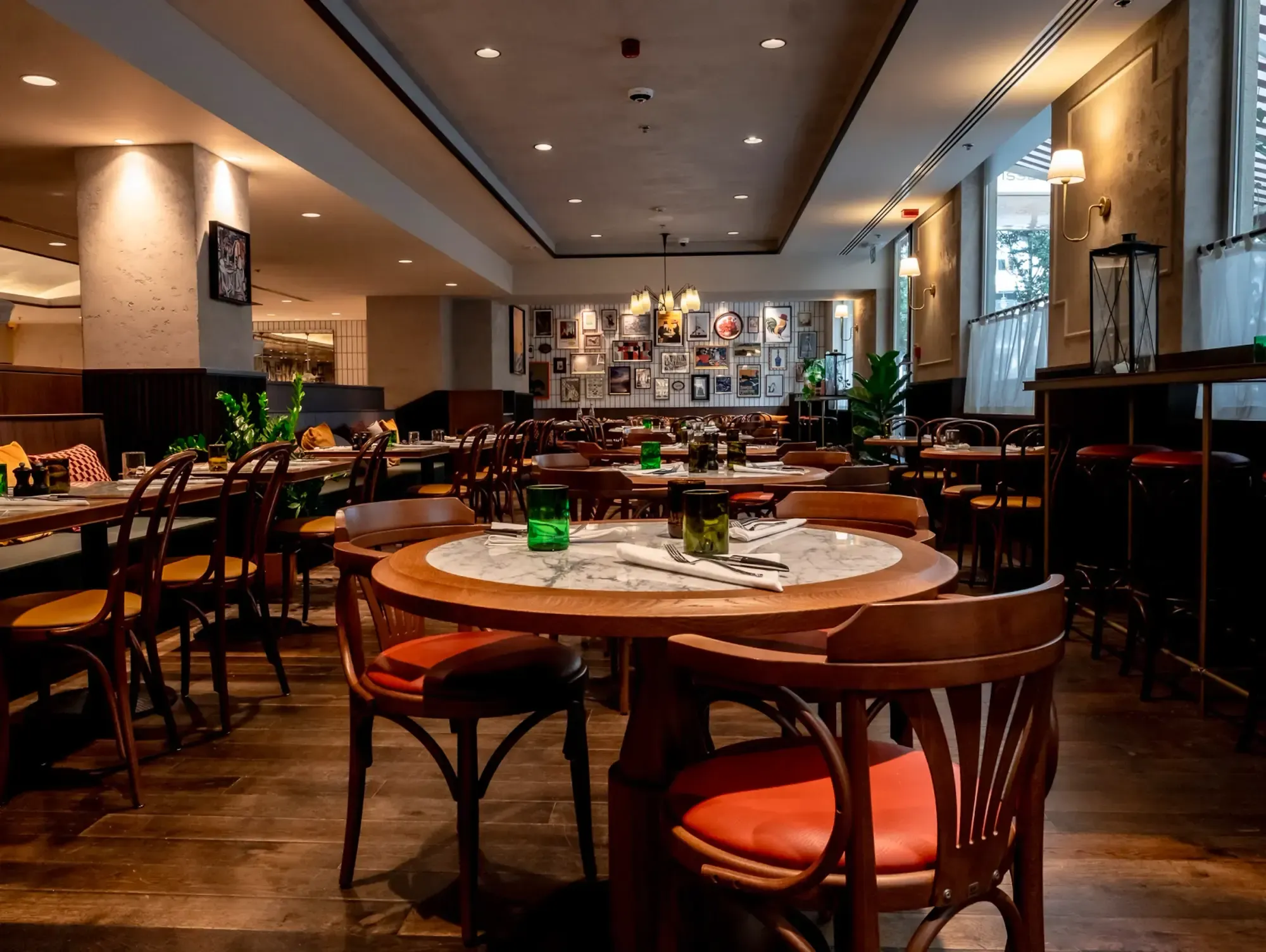 Rotisse’s big dining room, round tables and red chairs